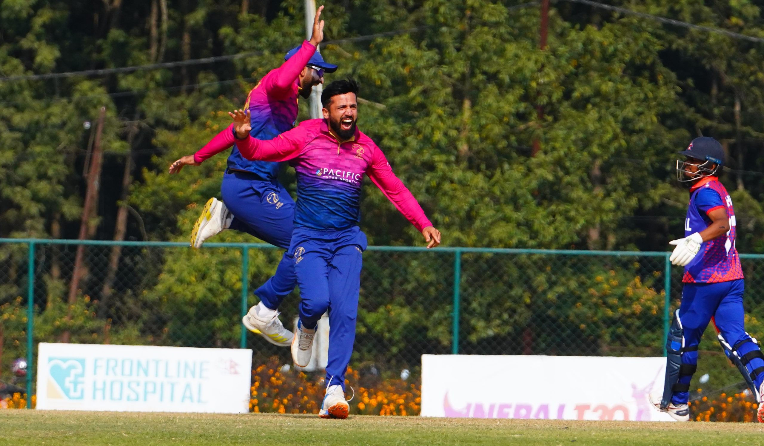 UAE offspinner Rohan Mustafa's happiness after taking the wicket of Rohit Paudel