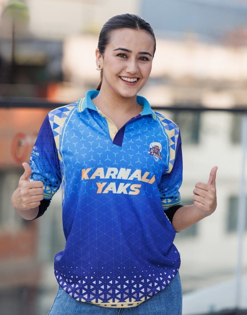 Actress Swastima Khadka showcases the Karnali Yaks jersey ahead of the Nepal Premier League